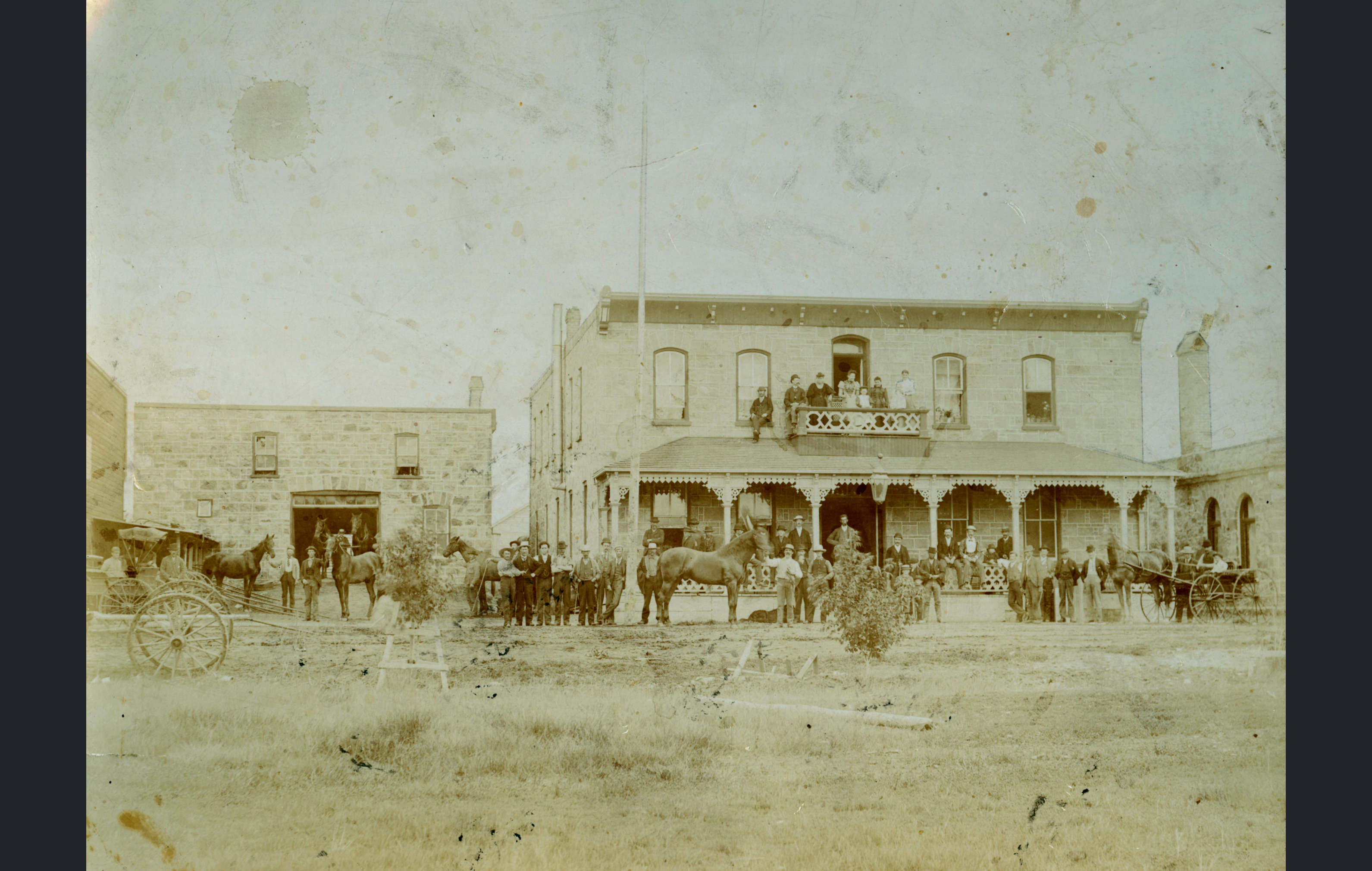 [Scanned photo of the Queen's Hotel and livery barn]