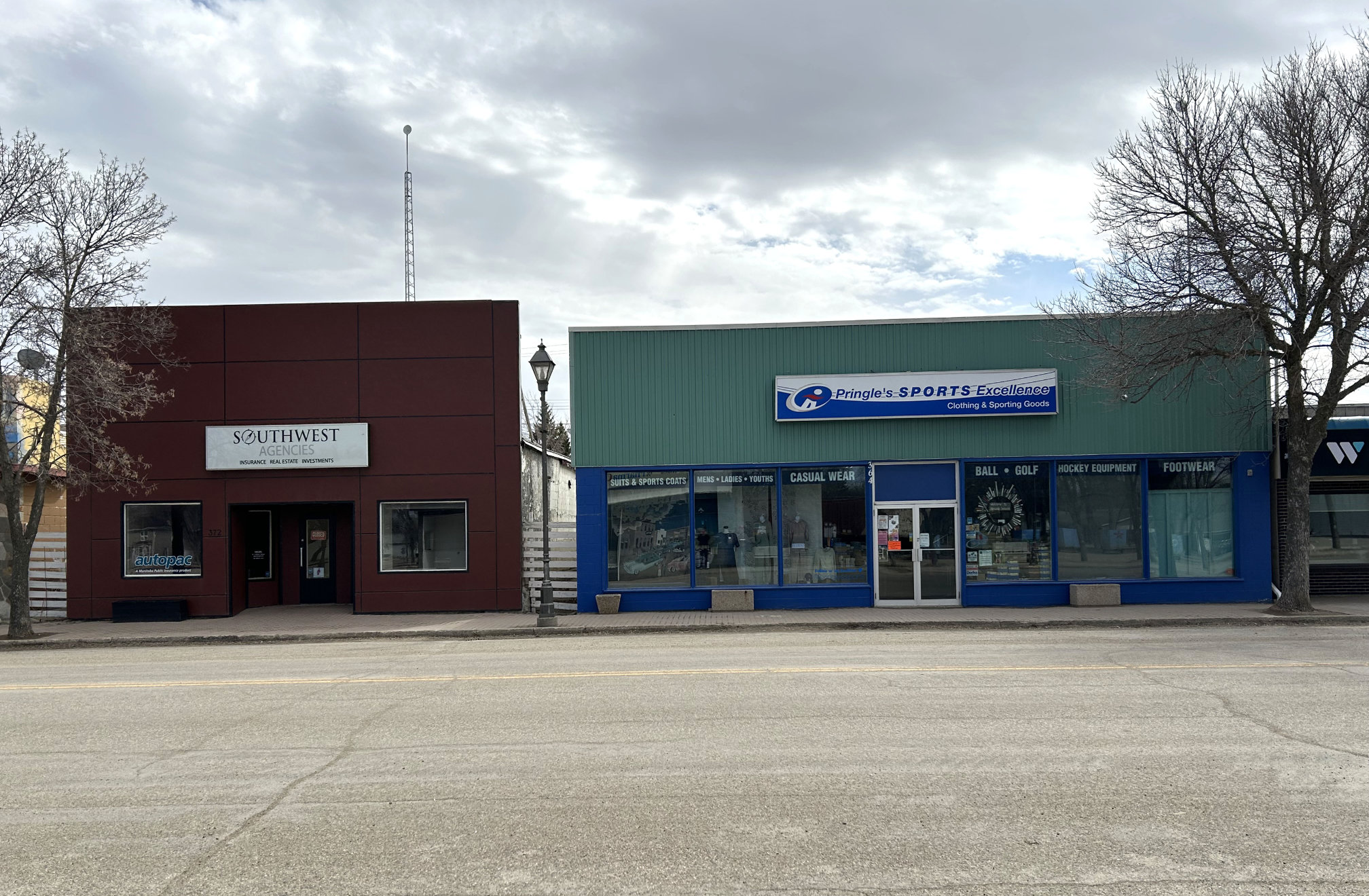[2024 photo of Southwest Agencies and Pringle's Sports Excellence (former site of the Queens Hotel and livery barn)]